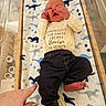baby, baby_boy, blanket, clothing, crib, cute, dinosaur_pattern, fingernails, foot, hand, indoor, infant, lying_down, newborn, pants, person, shirt, soft_texture, toddler, wooden_crib