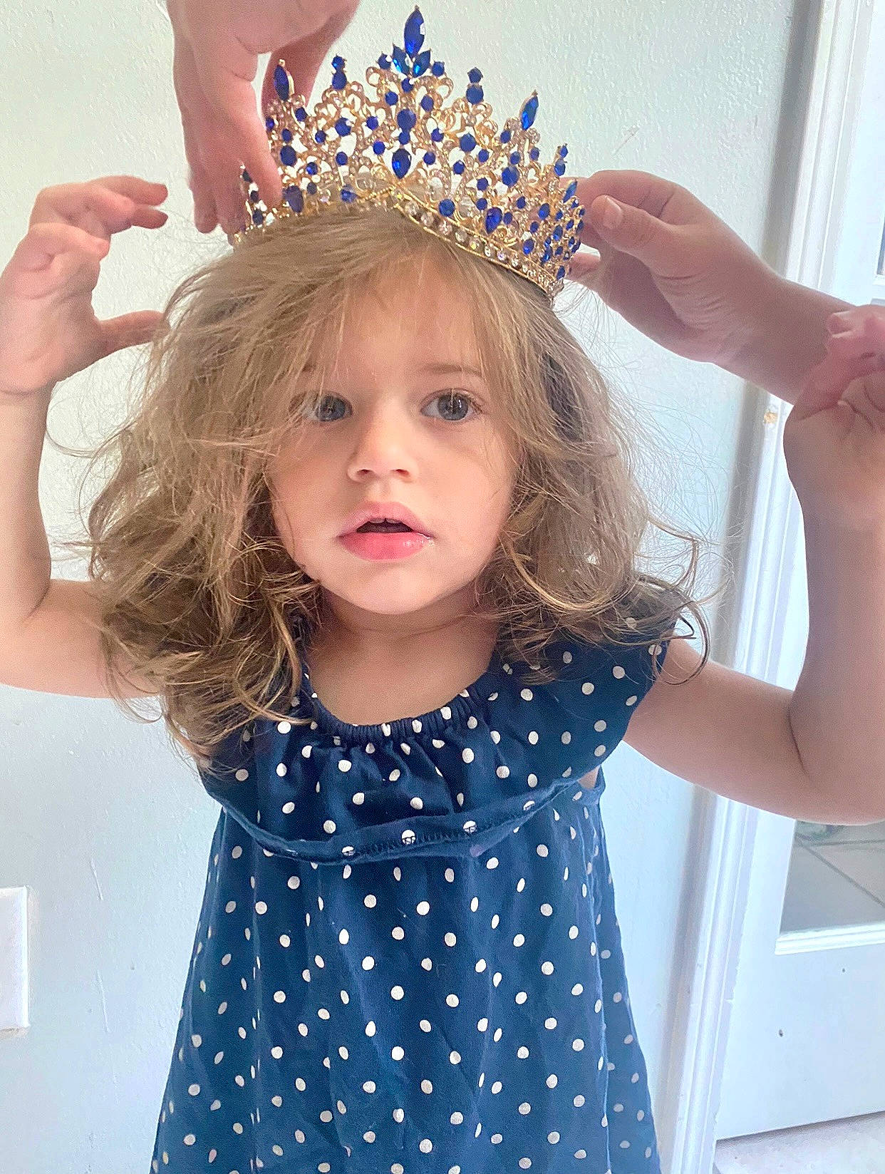 Hailey is registered to the contest to win money with this photo: aqua, azure, baby_toddler_clothing, blue, eyelash, fashion, finger, gesture, hair, hairstyle, hand, happy, person, pink, product, purple, sleeve, textile, tiara, toddler