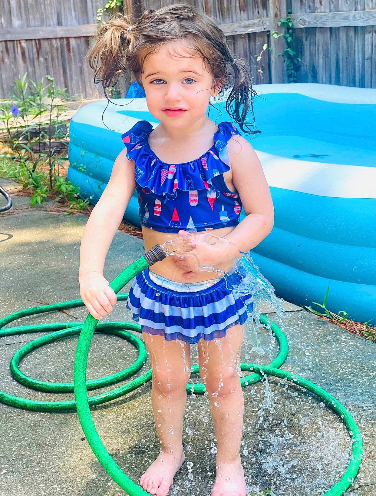Hailey is registered to the contest to win money with this photo: azure, barefoot, beauty, blue, child, electric_blue, event, fun, garden_hose, grass, green, happy, hose, human_leg, leisure, person, photograph, plant, summer, toddler