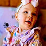 accessories, applique, baby, babylaughing, bodypart, clothing, dress, face, finger, formalwear, hand, happy, hat, head, headband, newborn, person, photography, portrait, smile