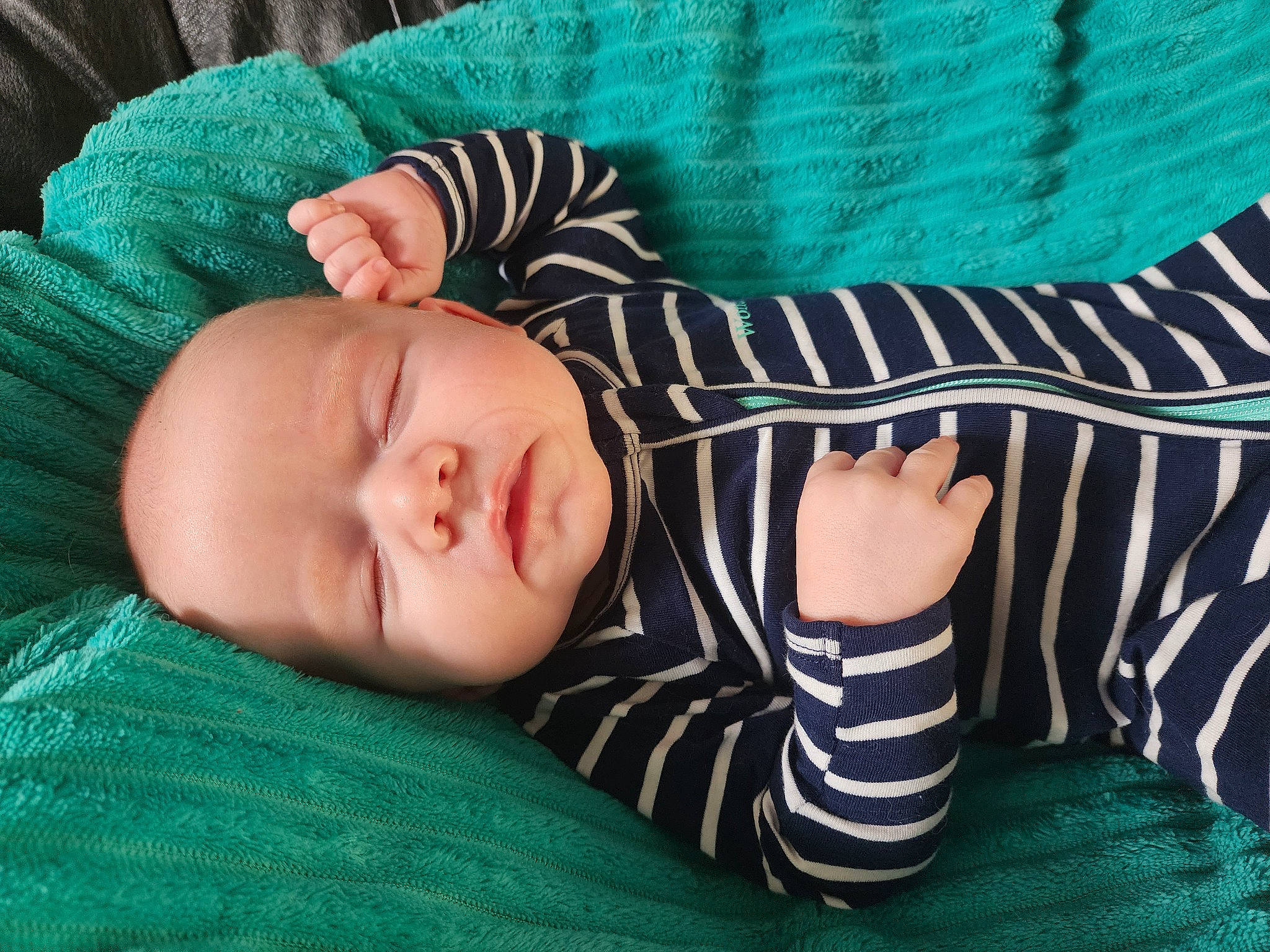 Leo is registered to the contest to win money with this photo: baby, baby_products, baby_sleeping, baby_toddler_clothing, cheek, child, comfort, facial_expression, grass, head, headgear, linens, pattern, person, room, sitting, skin, sleeve, textile, toddler