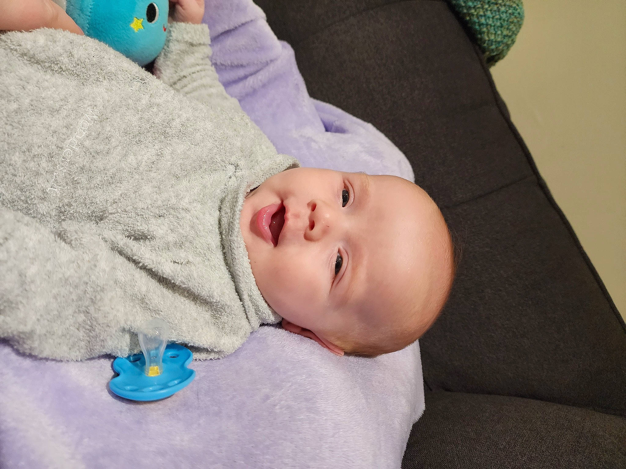 Leo is registered to the contest to win money with this photo: baby, baby_toddler_clothing, blue, cheek, child, comfort, facial_expression, hat, linens, mammal, pattern, person, portrait_photography, room, skin, sleeve, toddler, vertebrate