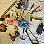 baby, shirtless, tools, chainsaw, hammer, pliers, gloves, wrench, screwdriver, utility_knife, drill, level_tool, carpentry_tools, jeans, indoor, floor, work_tools, equipment, person, child
