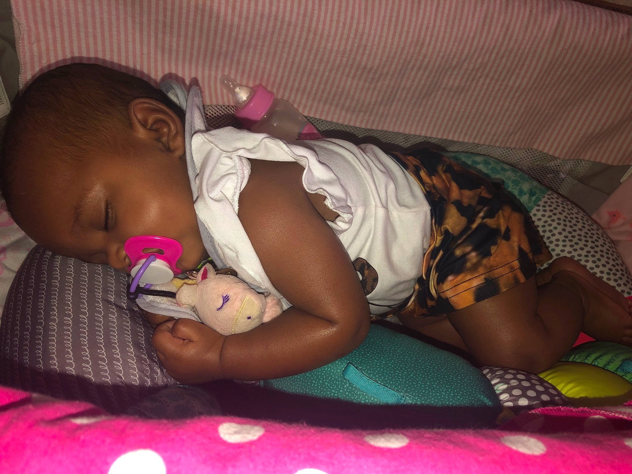 Zaini joined the competition — help win amazing prizes! arm, baby, baby_toddler_clothing, cheek, comfort, eye, facial_expression, finger, fun, human_body, human_leg, lap, leg, mouth, person, pink, purple, skin, thigh, toddler