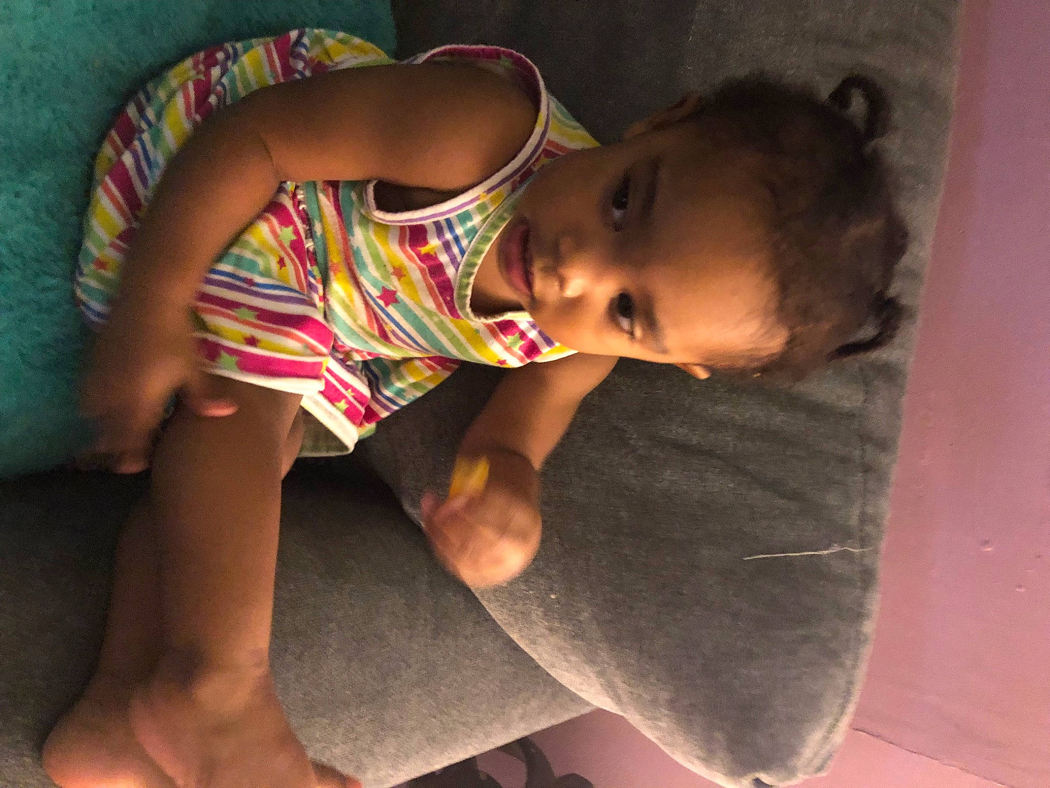 Javianna is registered to the contest to win money with this photo: baby, black_hair, cheek, chest, comfort, dress, elbow, fun, happy, human_leg, leg, lip, neck, nose, person, shoulder, skin, smile, thigh, toddler