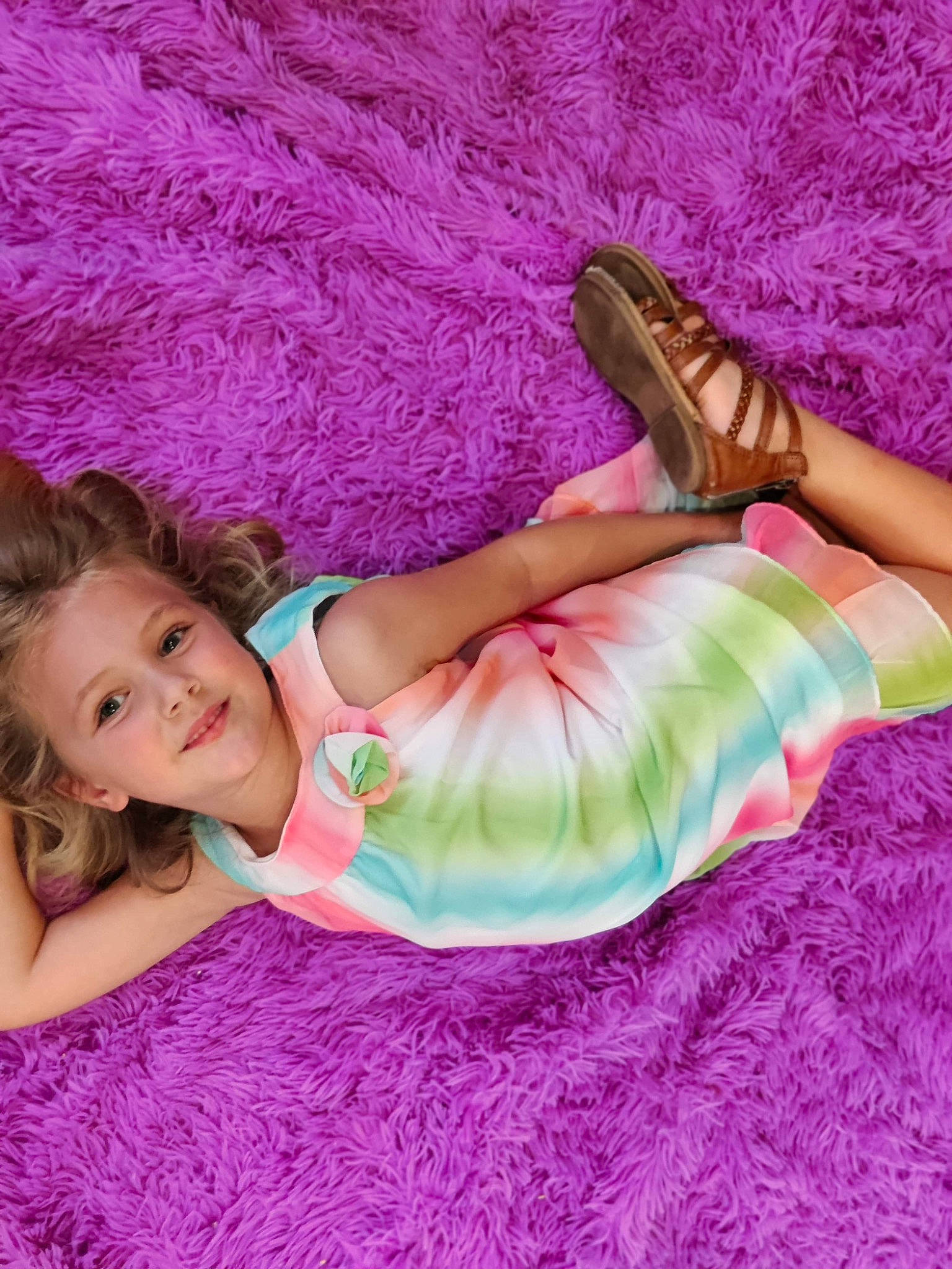 Vayda is registered to the contest to win money with this photo: aqua, baby_toddler_clothing, beauty, comfort, doll, dress, finger, happy, human_leg, joy, linens, magenta, person, pink, purple, skin, smile, textile, thigh, toddler