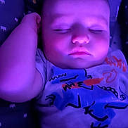 Sawyer is registered to the contest to win money with this photo: baby, sleeping, purple_light, infant, cute, face, tshirt, patterned_blanket, peaceful, closeup, child, resting, young, portrait, soft_light, indoors, cozy, relaxation, skin, hand