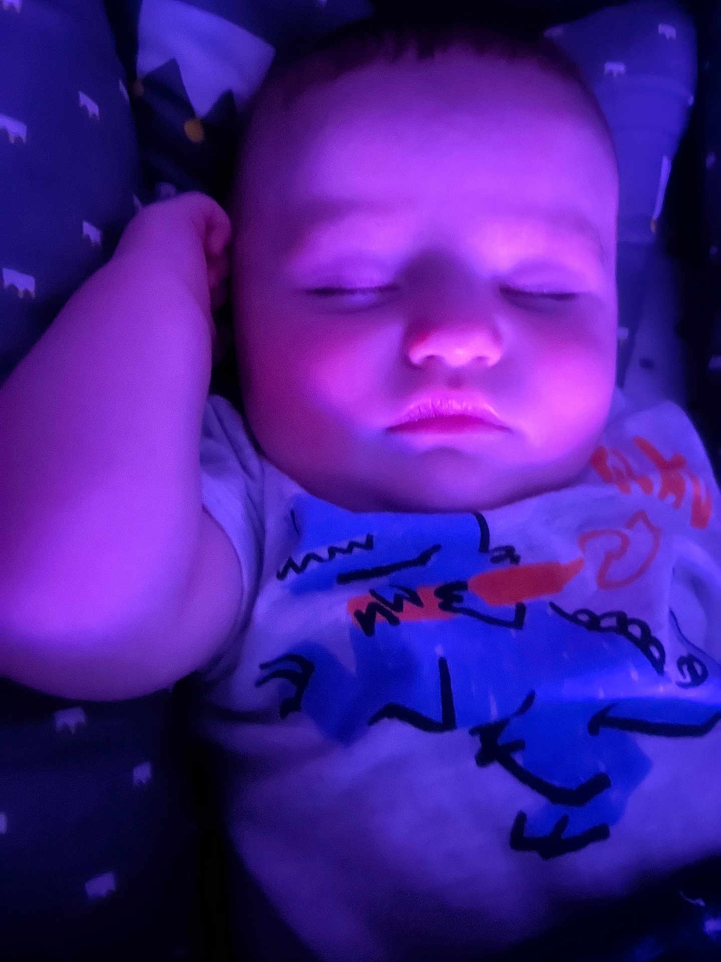 Sawyer is registered to the contest to win money with this photo: baby, sleeping, purple_light, infant, cute, face, tshirt, patterned_blanket, peaceful, closeup, child, resting, young, portrait, soft_light, indoors, cozy, relaxation, skin, hand