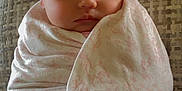 Taylor is registered to the contest to win money with this photo: baby, blanket, bow, child, clothing, couch, cozy, cute, face, furniture, headband, indoors, infant, peaceful, portrait, resting, sleeping, soft, toddler, wrapped
