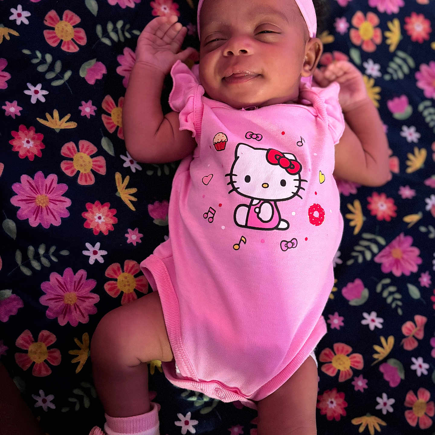 Tashayla joined the competition — help win amazing prizes! baby, blanket, child, closeup, cute, floral_pattern, flower, headband, indoors, infant, lying_down, onesie, peaceful, person, pink_clothing, skin, sleeping, smiling, socks, toddler
