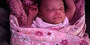 Tashayla is registered to the contest to win money with this photo: baby, blanket, child, closeup, comfort, cozy, cute, cute_face, floral, indoor, infant, newborn, peaceful, pink, portrait, resting, sleeping, soft, warm, wrapped