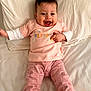Daisy is registered to the contest to win money with this photo: baby, bed, casual_wear, celebration, cherry_pattern, child, cute, first_easter, happy, indoors, infant, joyful, laying_down, person, pink_clothing, portrait, smiling, toddler, white_bed_sheet, young_child