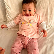 Daisy joined the competition — help win amazing prizes! baby, bed, cheerful, child, cute, easter, fabric, happy, indoors, infant, lying_down, pants, pattern, person, pillow, pink_clothing, smile, soft, tshirt, young_child
