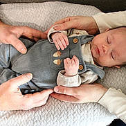 Ezekiel a rejoint le concours — aidez-le/la à gagner de superbes lots ! baby, newborn, infant, sleeping, hands, adult_hands, blanket, quilted_blanket, overalls, buttons, clothing, skin, face, eyes_closed, peaceful, holding, family, close_up, cozy, portrait