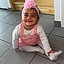 Harmonie a rejoint le concours — aidez-le/la à gagner de superbes lots ! toddler, child, pink_headband, bow, smile, white_shirt, pink_overalls, sitting, floor, tiles, wooden_stairs, indoor, cute, happy, playful, long_sleeves, headwear, person, young_child, casual_clothing