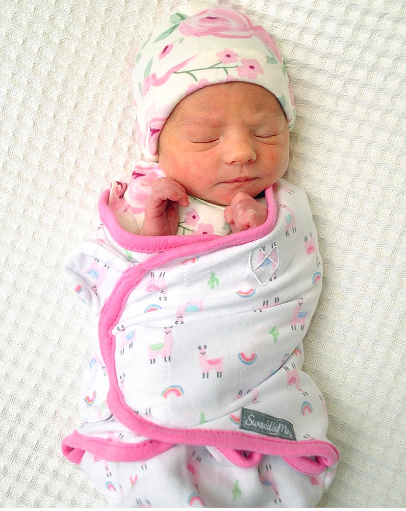 Blakely is registered to the contest to win money with this photo: baby, baby_products, baby_sleeping, baby_toddler_clothing, beanie, cap, carmine, cheek, child, comfort, face, headwear, knit_cap, linens, lip, pattern, person, pink, sitting, skin