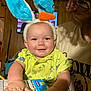 Bowen joined the competition — help win amazing prizes! baby, child, bunny_ears, carrot, smile, yellow_shirt, dinosaur_print, nutrition_facts, milk_chocolate, adult, glasses, facial_hair, indoor, wood_paneling, television, table, hand, happy, person, cozy