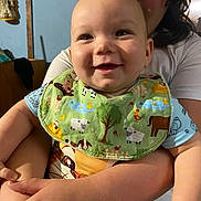 Bowen joined the competition — help win amazing prizes! baby, child, smiling, bib, indoor, person, holding, happy, cute, face, young, arms, clothing, sleeve, background, doll, wood, wall, portrait, family