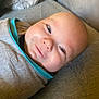 Bowen is registered to the contest to win money with this photo: baby, smile, face, swaddle, clothing, infant, portrait, person, cute, happy, lying_down, skin, head, newborn, cozy, closeup, indoors, soft, fabric, comfort