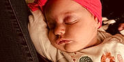 Ailey joined the competition — help win amazing prizes! baby, sleeping, headband, pink, onesie, embroidery, blanket, cozy, cute, infant, child, soft_lighting, face, peaceful, resting, clothing, closeup, indoor, warm_tones, portrait