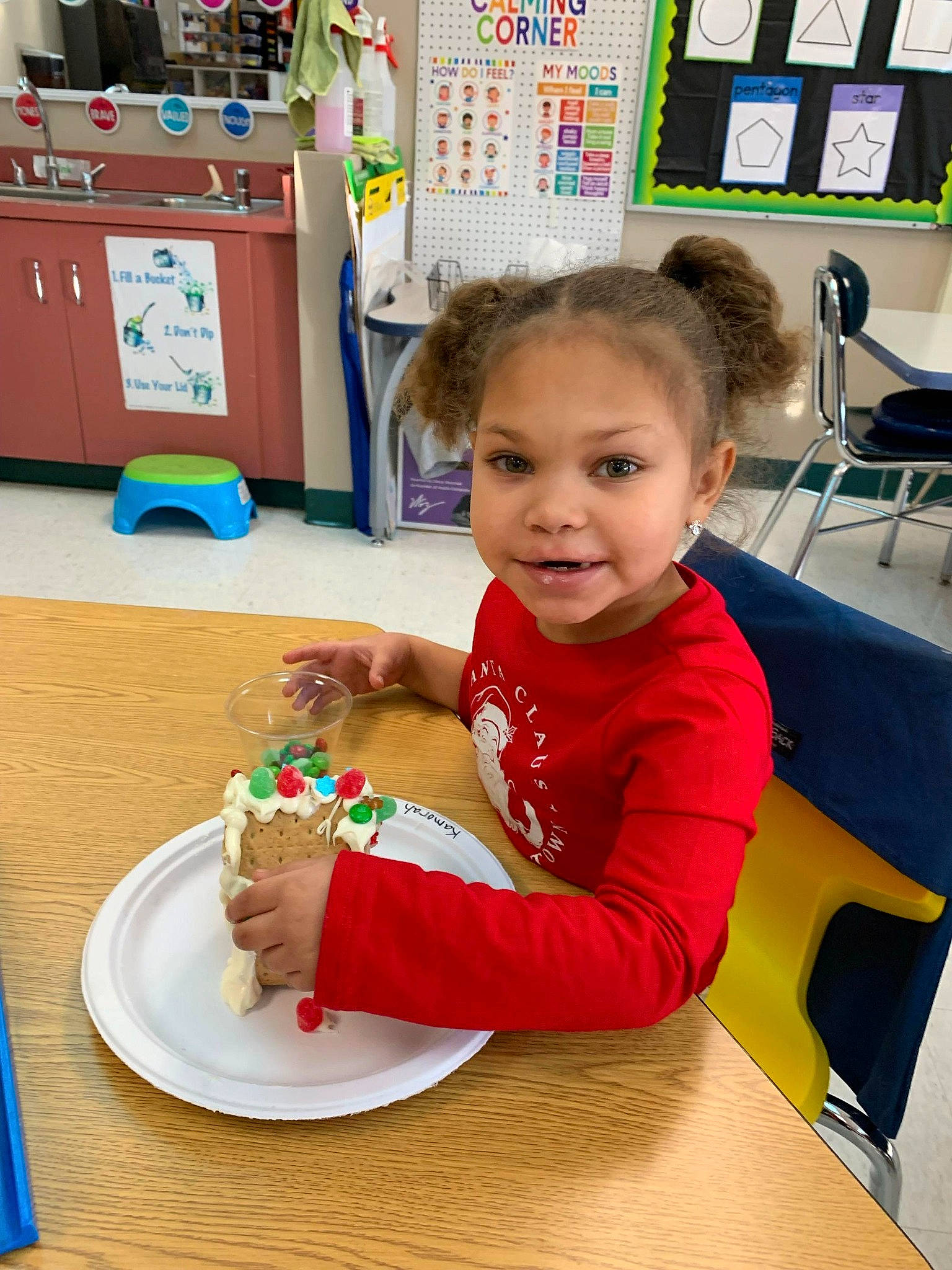 Kamorah is registered to the contest to win money with this photo: baking, cabinetry, chair, child, desk, education, event, flooring, food, fun, kindergarten, leisure, person, plate, play, room, smile, sweetness, table, tableware