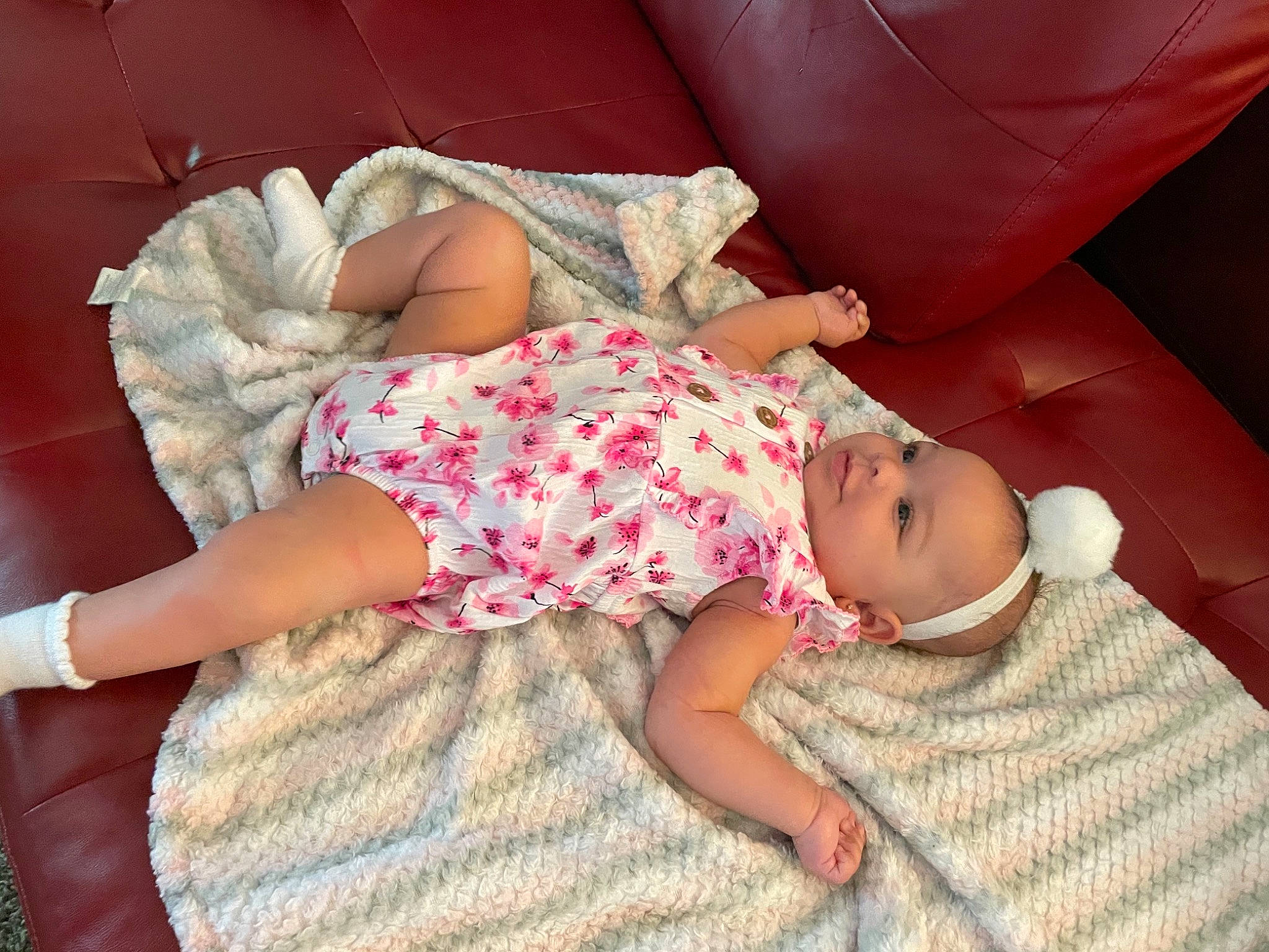 Milan is registered to the contest to win money with this photo: arm, baby, baby_toddler_clothing, comfort, finger, foot, hand, human_body, human_leg, joint, knee, lap, leg, linens, person, pink, skin, sock, textile, thigh