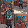 child, boy, jacket, cap, brick_wall, mural, painting, drum, outdoor, concrete, sunlight, shadow, colorful_clothing, street_art, urban, person, casual, standing, playful, daylight