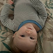 Ashton joined the competition — help win amazing prizes! baby, child, striped_clothing, onesie, blanket, pattern, indoor, face, head, hands, motion_blur, portrait, cute, infant, lying_down, soft_lighting, young_child, skin, expression, casual