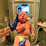 newborn, baby, hospital, medical_equipment, gloved_hands, diaper, umbilical_clamp, temperature_display, infant, person, healthcare, clinic, patient, skin, cute, sleepy, neonatal, birth, care, monitor
