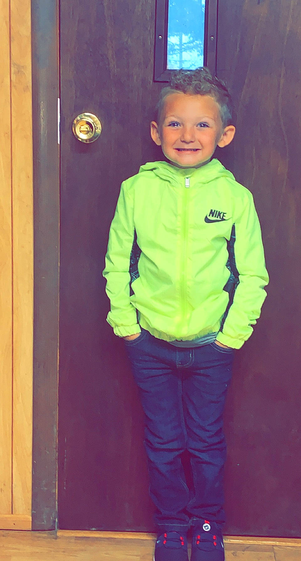 Kamdyn is registered to the contest to win money with this photo: baby_toddler_clothing, clothing, cool, door, eye, face, gesture, hair, happy, head, jeans, joy, outerwear, person, plant, purple, red, sleeve, smile, standing