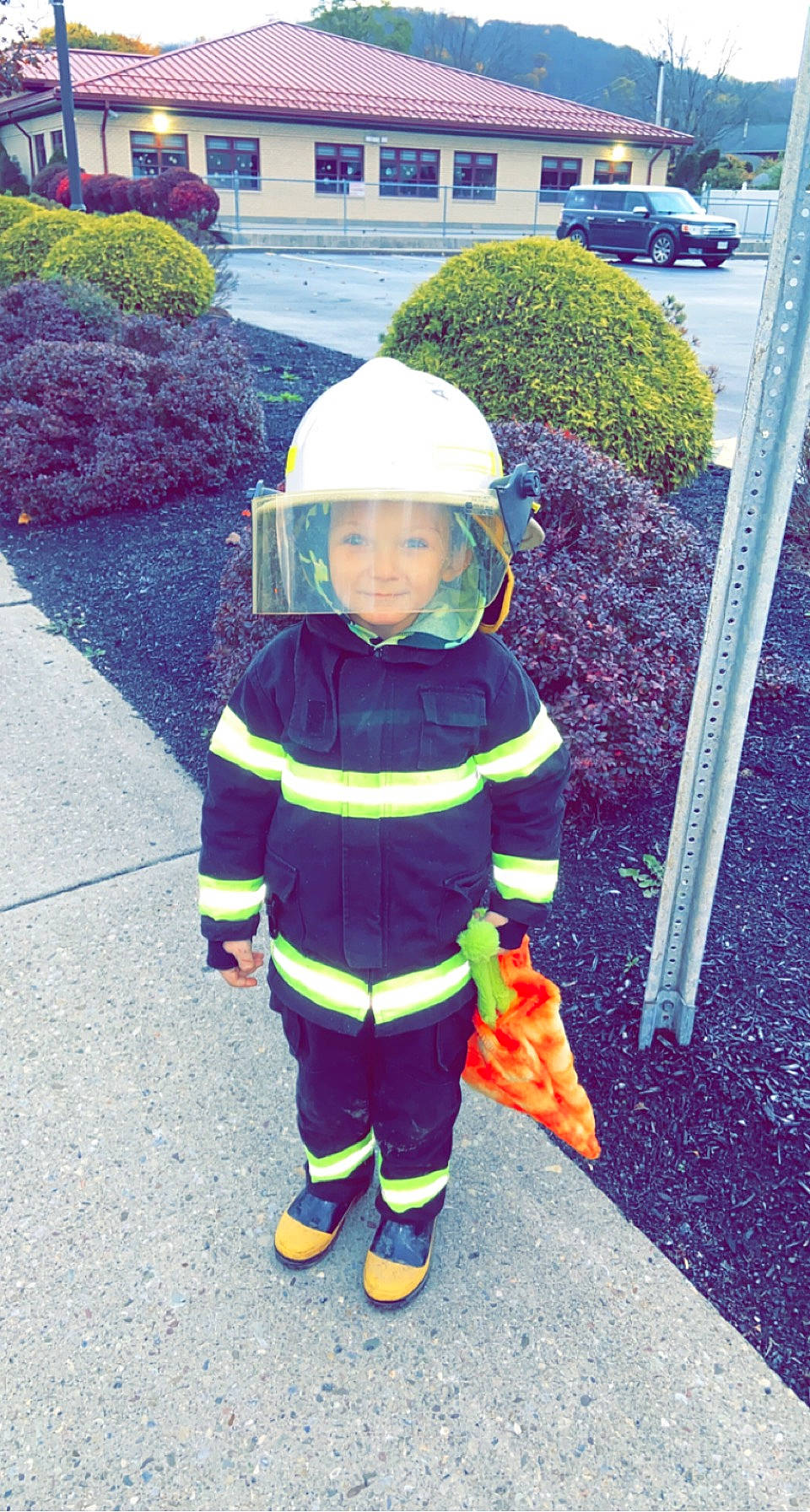 Kamdyn joined the competition — help win amazing prizes! asphalt, boot, child, driveway, fictional_character, flooring, footwear, fun, grass, headwear, hedge, helmet, high_visibility_clothing, person, personal_protective_equipment, plant, recreation, road, road_surface, shrub