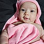 adorable, baby, bathtime, blanket, bright_eyes, child, closeup, cozy, cute, earring, hood, indoor, infant, lying_down, pink_towel, portrait, pose, skin, smile, soft_towel