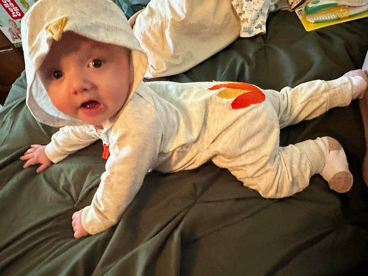 Jaylen is registered to the contest to win money with this photo: baby, baby_products, baby_safety, baby_toddler_clothing, child, comfort, flooring, foot, fun, grass, hat, headwear, human_body, linens, person, room, sitting, sleeve, toddler, tree