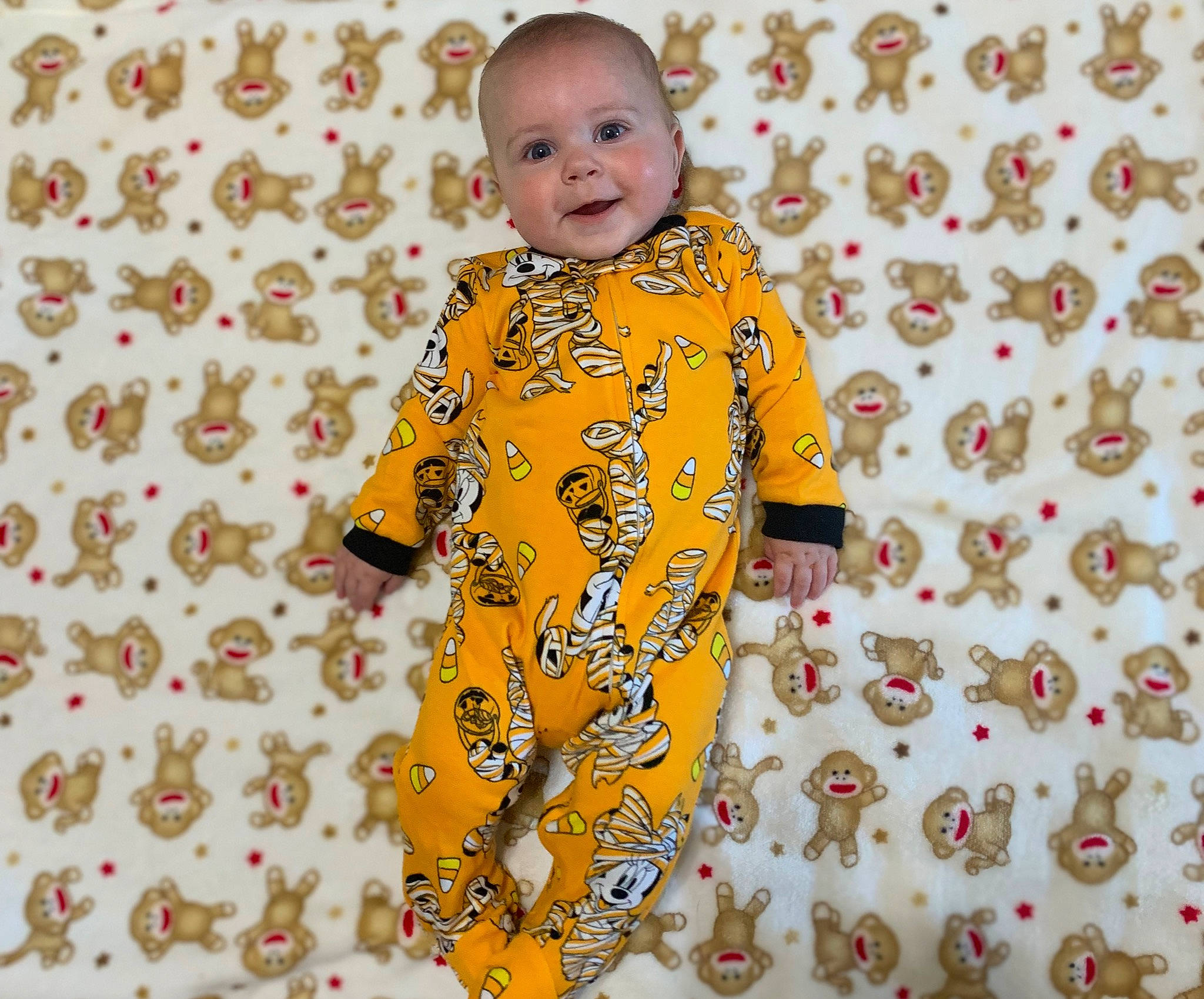 Guy is registered to the contest to win money with this photo: baby, baby_toddler_clothing, child, collar, facial_expression, flooring, font, fun, happy, joy, linens, orange, pattern, people_in_nature, person, sleeve, smile, t_shirt, textile, toddler