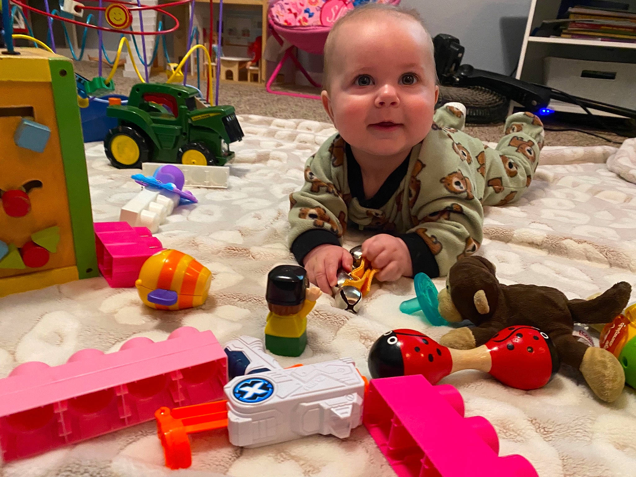 Guy is registered to the contest to win money with this photo: art, baby, baby_products, baby_toys, child, computer_keyboard, event, fun, home_appliance, person, play, product, room, smile, television, tire, toddler, toy, toy_block, wheel