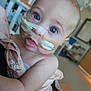Georgia Ann is registered to the contest to win money with this photo: baby, infant, blue_eyes, nasal_tube, medical_tape, hospital, blanket, floral_pattern, close_up, face, skin, person, child, healthcare, indoor, young, curious, patient, cute, soft_light