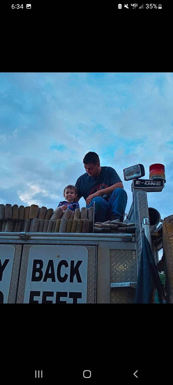 Karson is registered to the contest to win money with this photo: advertising, auto_part, automotive_tire, automotive_wheel_system, cloud, crowd, engineering, event, font, hat, job, joy, leisure, metal, motor_vehicle, person, recreation, sitting, sky, stage_equipment