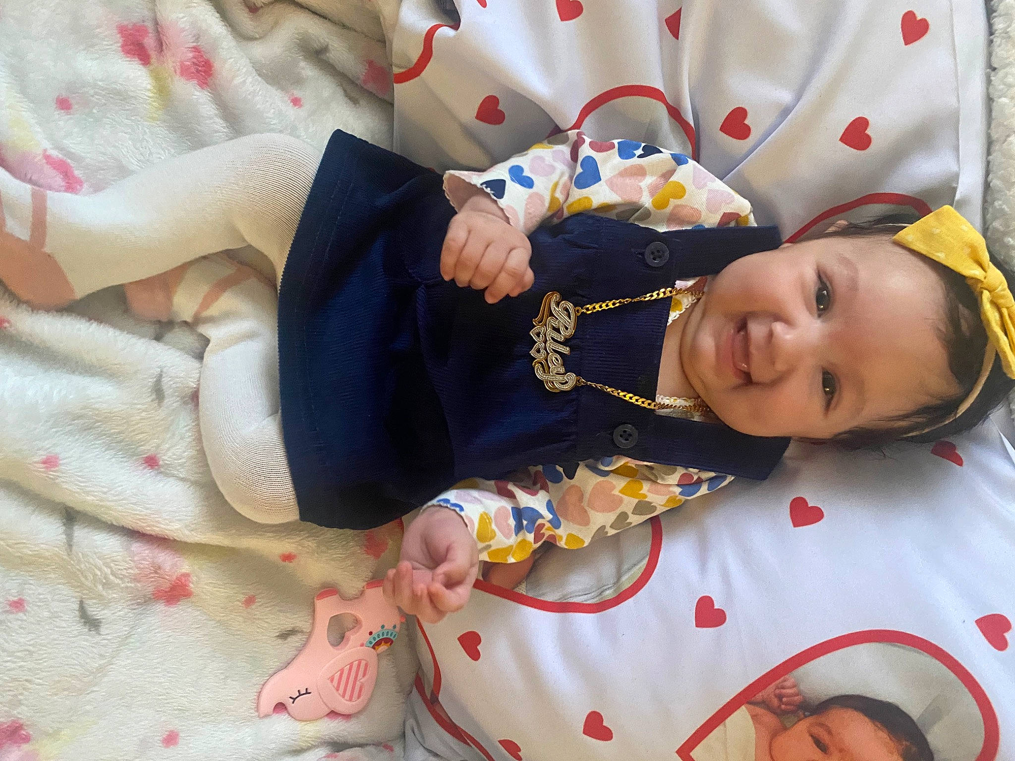 Riley Ray is registered to the contest to win money with this photo: baby, baby_products, baby_toddler_clothing, child, comfort, eye, happy, linens, pattern, person, room, sitting, skin, sleeve, smile, toddler, white