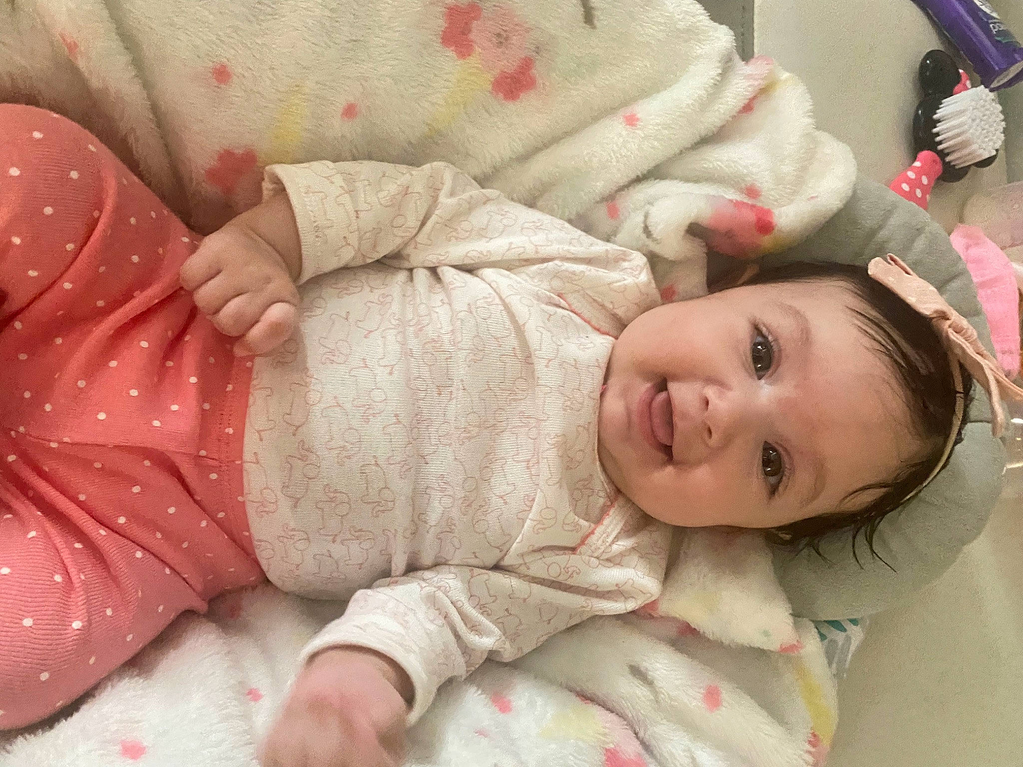 Riley Ray is registered to the contest to win money with this photo: baby, baby_toddler_clothing, beauty, cheek, child, comfort, face, facial_expression, happy, head, human, linens, lip, pattern, person, pink, skin, sleeve, smile, textile