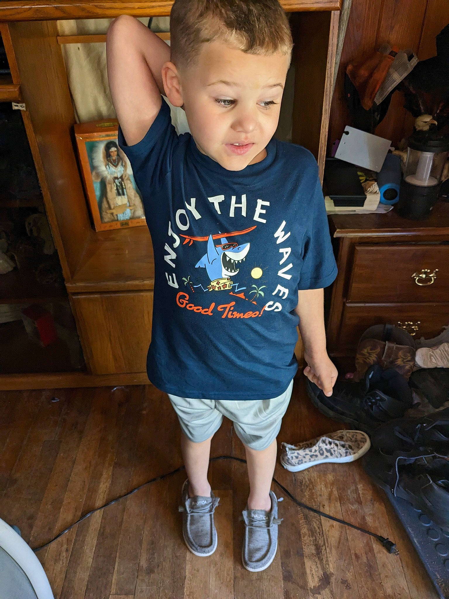 Cody is registered to the contest to win money with this photo: baby_toddler_clothing, cabinetry, chin, drawer, electric_blue, floor, flooring, fun, happy, hardwood, human_leg, person, shoe, shorts, sleeve, standing, t_shirt, thigh, toddler, trunk