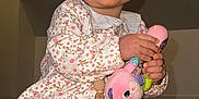 Adèle participe au concours pour gagner de l'argent avec cette photo : baby, child, smiling, toy, plush_toy, sitting, floral_dress, white_tights, happy, indoor, blanket, cute, face, person, young_child, playing, hands, feet, closeup, portrait