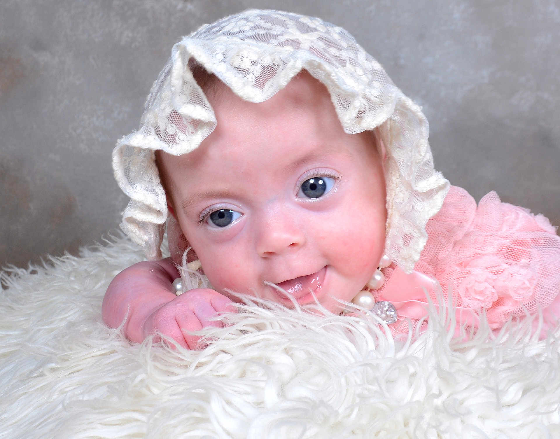 Xena joined the competition — help win amazing prizes! baby, infant, blue_eyes, lace_bonnet, pink_clothing, pearls, fluffy_blanket, close_up, cute, resting, portrait, soft_texture, child, face, smile, newborn, adorable, innocence, cute_expression, cozy
