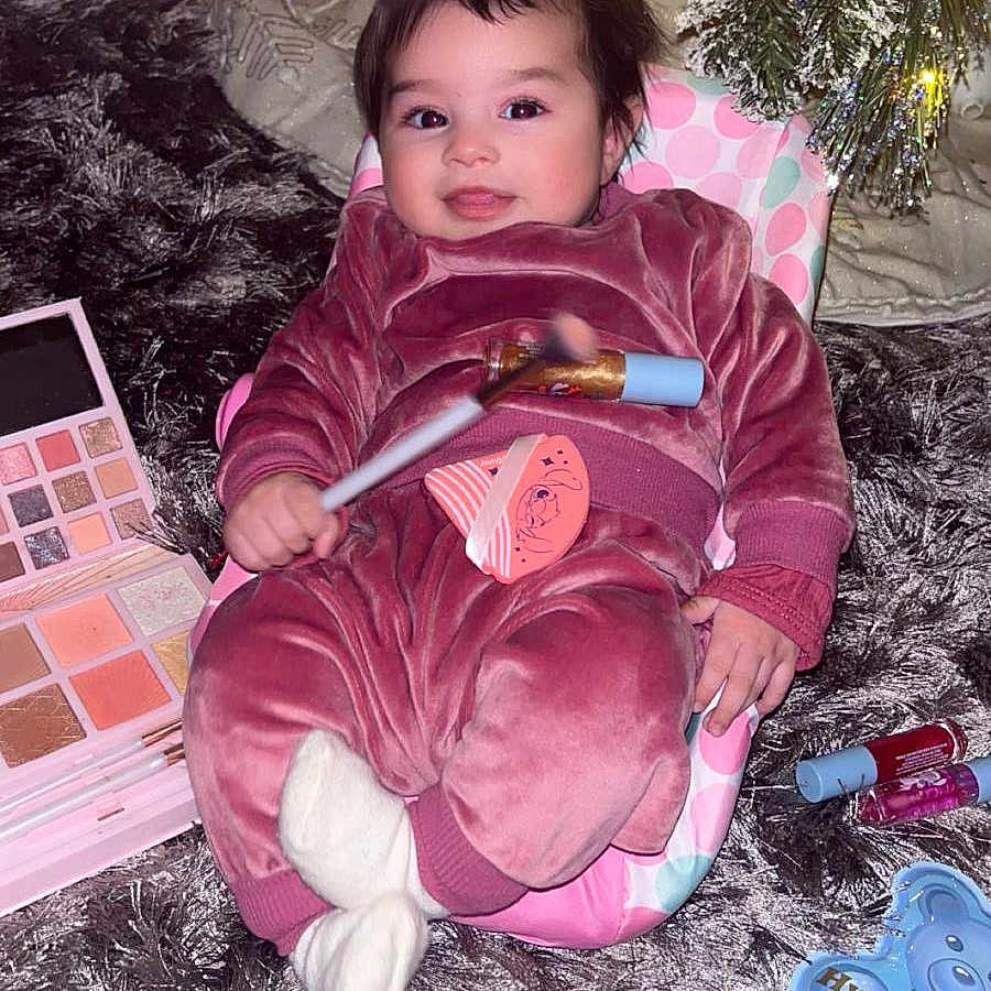 Amira joined the competition — help win amazing prizes! baby, brush, clothing, coat, cosmetics, cutlery, device, face, head, jacket, lighting, lipstick, person, photography, plant, portrait, pottedplant, purple, spoon, tool
