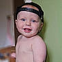 baby, child, smiling, blue_eyes, cap, hat, bare_chest, drool, indoor, person, cute, happy, portrait, young, infant, skin, face, headwear, standing, expression