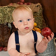 Zion joined the competition — help win amazing prizes! baby, child, potato, dirt, face, hand, blue_eyes, denim_shorts, suspenders, bare_chest, boots, hay, rustic, farm, background, sitting, curious, indoor, person, portrait