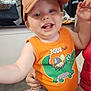 Zion joined the competition — help win amazing prizes! toddler, child, cap, orange_tank_top, cartoon_crocodile, cartoon_turtle, smiling, reaching_out, indoor, adult_hand, casual_clothing, cute, happy, person, baby, shorts, supporting_hand, playful, closeup, portrait