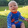 baby, child, smiling, outdoor, grass, pond, trees, sunlight, blue_swimsuit, orange_details, striped_sleeves, sitting, happy, nature, water, summer, cute, person, young_child, playful