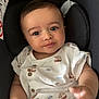 baby, button, car_seat, child, clothing, cute, expression, eyes, fabric, face, hand, indoor, infant, onesie, pattern, portrait, seat, skin, smile, young