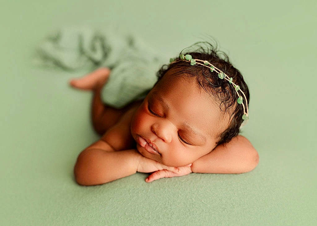 Kelani is registered to the contest to win money with this photo: arm, baby, baby_toddler_clothing, cheek, child, comfort, eyebrow, eyelash, flash_photography, flooring, grass, happy, headband, headgear, headpiece, iris, person, skin, smile, toddler