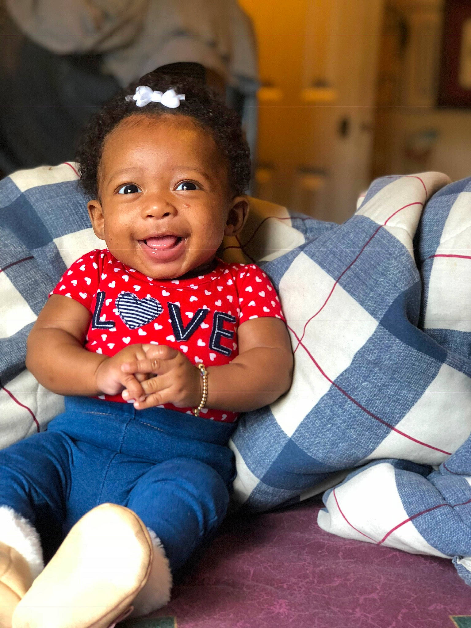 Legacy is registered to the contest to win money with this photo: baby, cheek, child, joy, person, plaid, sitting, skin, smile, toddler